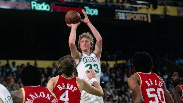 Larry Bird shoots over defenders during a game, HD Desktop Wallpaper