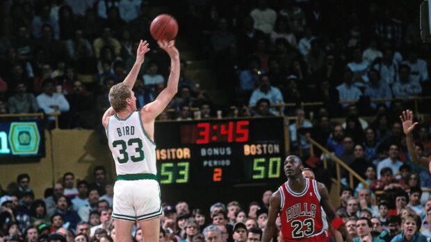 Larry Bird shoots a jump shot over Michael Jordan in a crowded basketball arena, HD Desktop Wallpaper
