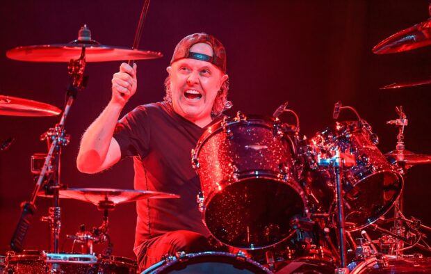 Lars Ulrich is playing drums passionately during a live performance, HD Desktop Wallpaper