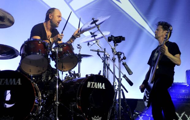 Lars Ulrich is playing drums during a live concert performance, HD Desktop Wallpaper