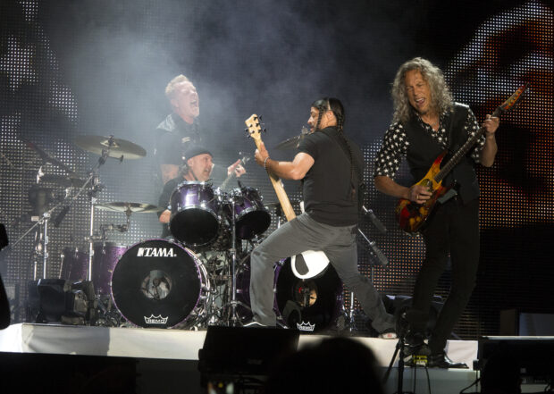Lars Ulrich is playing drums during a concert performance with his band, 2K Desktop Wallpaper
