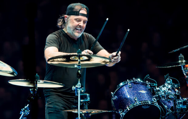 Lars Ulrich performing on drums with drumsticks in hand during a live show, HD Desktop Wallpaper