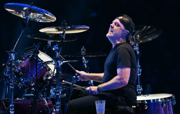 Lars Ulrich is playing drums passionately during a live concert, HD Desktop Wallpaper