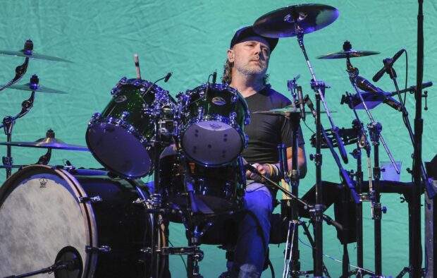 Lars Ulrich is performing with his drum set during a live concert, HD Desktop Wallpaper