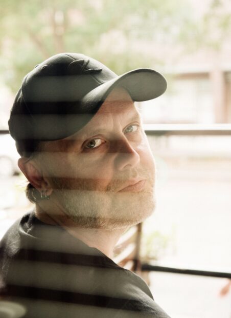 Lars Ulrich looks thoughtfully through a window with a hat, HD Mobile Wallpaper
