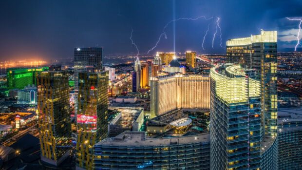 Las Vegas skyline with illuminated buildings and lightning in the night sky