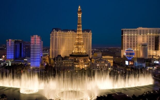 Las Vegas skyline with illuminated Eiffel Tower and fountain show at night