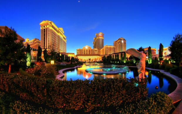 Night view of Las Vegas skyline with illuminated buildings and fountains