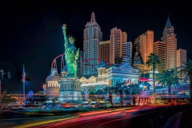 Nighttime view of Las Vegas skyline with replica Statue of Liberty and illuminated buildings