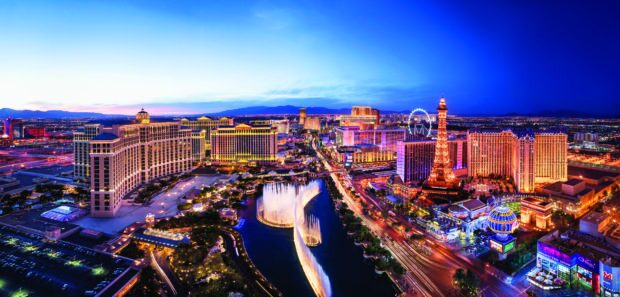 Las Vegas skyline at dusk showcasing famous landmarks and fountains in vibrant city lights