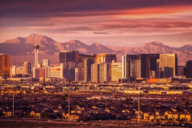Las Vegas skyline in golden sunset light with mountain landscape in the background
