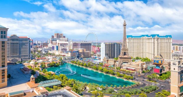 Las Vegas skyline with famous landmarks and fountains on a clear sunny day