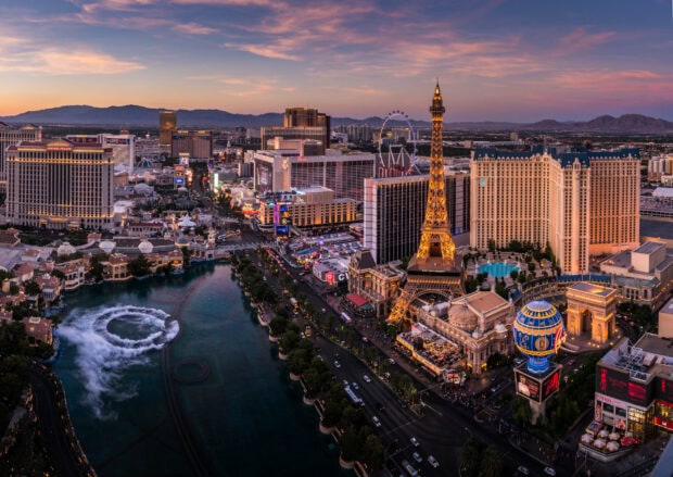 A stunning Las Vegas skyline view at sunset with iconic landmarks and mountains in the background