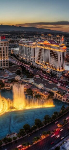 Las Vegas skyline with illuminated fountains and Caesars Palace at sunset