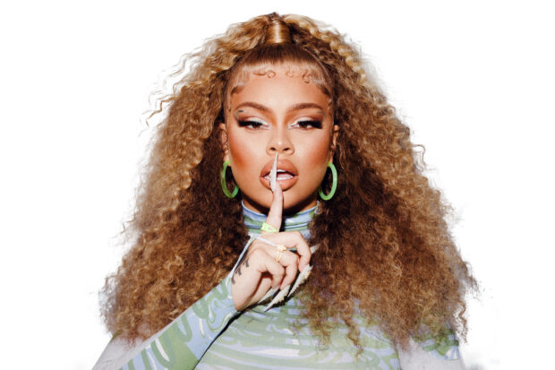 Latto Wallpapers shows a woman with voluminous curly hair and green earrings posing with a finger on her lips, 2K Desktop Wallpaper