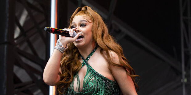 Latto performs energetically on stage during a concert, HD Desktop Wallpaper