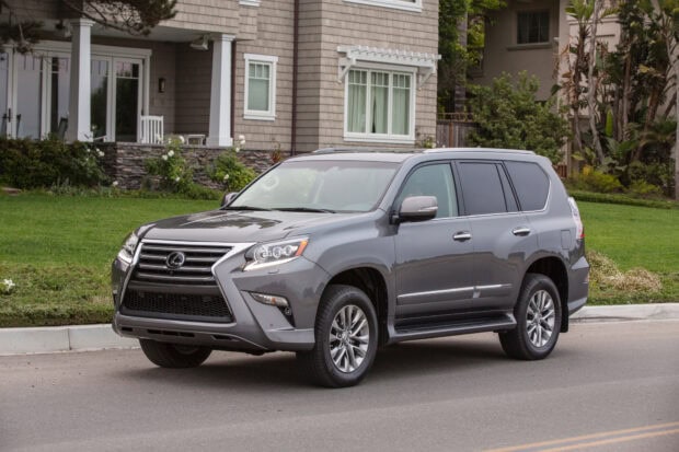 A silver Lexus GX is parked on a quiet residential road in front of houses, HD Desktop Wallpaper