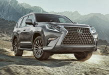 A Lexus GX driving through rocky mountain terrain under a cloudy sky, 2K Desktop Wallpaper