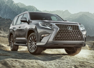 A Lexus GX driving through rocky mountain terrain under a cloudy sky, 2K Desktop Wallpaper