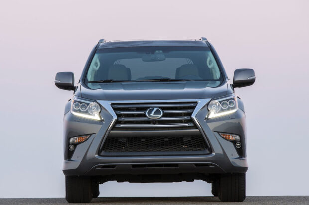 A grey Lexus GX is shown from the front with headlights on against a clear sky, HD Desktop Wallpaper