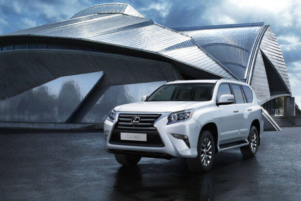 A white Lexus GX is parked near a modern building with metallic architecture, HD Desktop Wallpaper