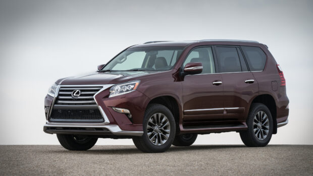 A deep red Lexus GX luxury SUV parked on a paved surface under overcast sky, 4K Desktop Wallpaper