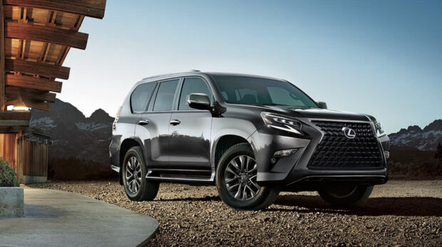 A Lexus GX SUV is parked near a wooden cabin with mountains in the background, HD Desktop Wallpaper