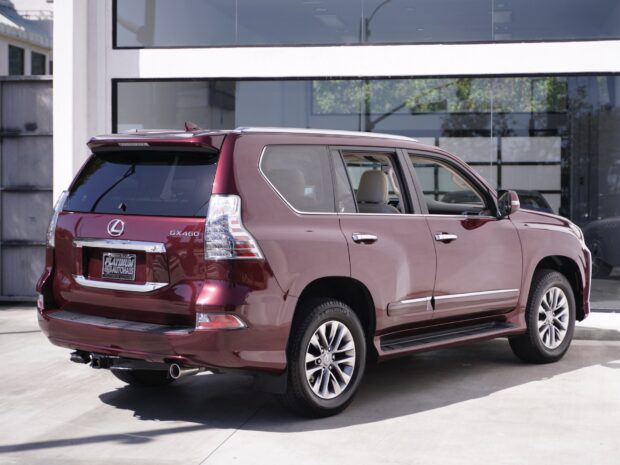 A deep red Lexus GX460 SUV is parked outside a modern building on a sunny day, HD Desktop Wallpaper