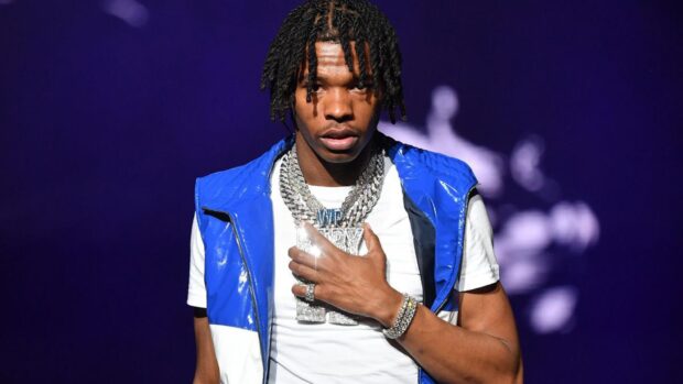 Lil Baby is wearing a blue vest with diamond chains on stage, HD Desktop Wallpaper