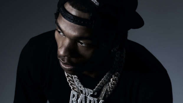 Lil Baby wears a cap and heavy chains in this close up portrait, 2K Desktop Wallpaper