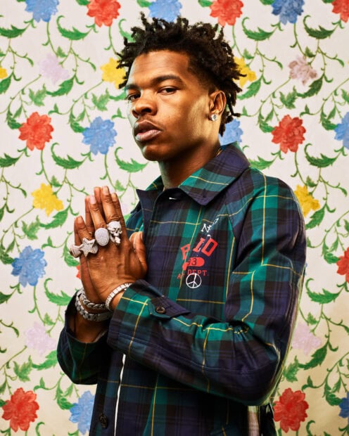 Lil Baby in a green and blue plaid jacket posing with hands together in front of floral wallpaper, HD Mobile Wallpaper