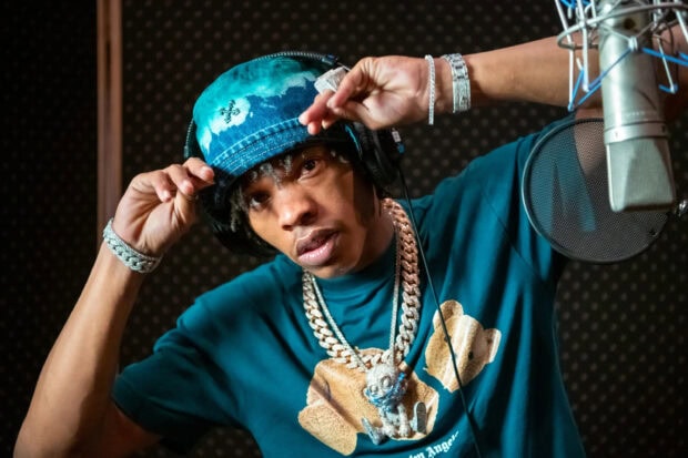 Lil Baby wearing a blue shirt and hat with chains in a recording studio, 2K Desktop Wallpaper