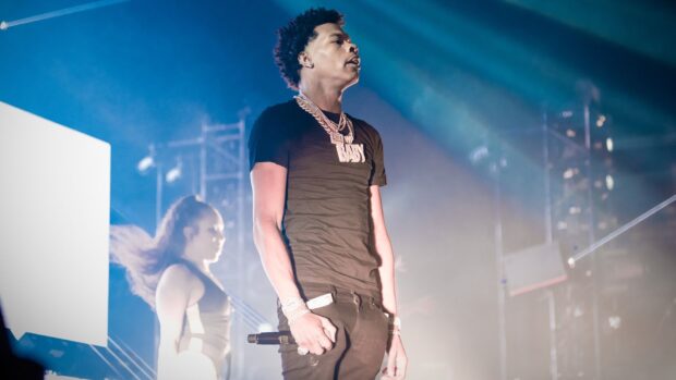Lil Baby is performing on stage with a microphone and jewelry, HD Desktop Wallpaper
