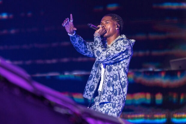 Lil Baby is singing passionately with a microphone during a concert, 2K Desktop Wallpaper