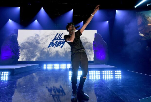 Lil Baby is performing live during a concert with bright lights, HD Desktop Wallpaper