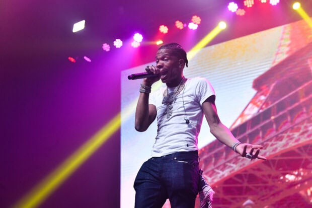 Lil Baby delivers a dynamic performance during a live concert with vibrant stage lights, HD Desktop Wallpaper