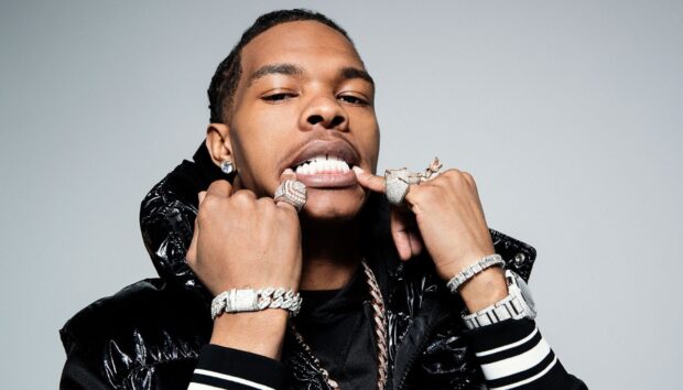 Lil Baby showing his jewelry rings and grill in a confident pose, HD Desktop Wallpaper