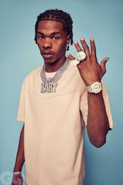Lil Baby wearing diamond chains and rings against a blue background, 2K PC Wallpaper