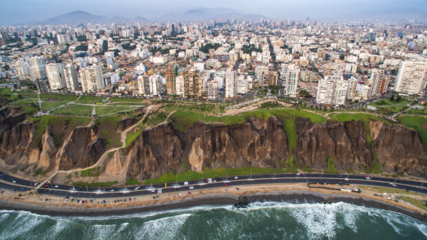 The Lima Peru cityscape shows cliffs by the ocean with buildings in the background, HD Desktop Wallpaper