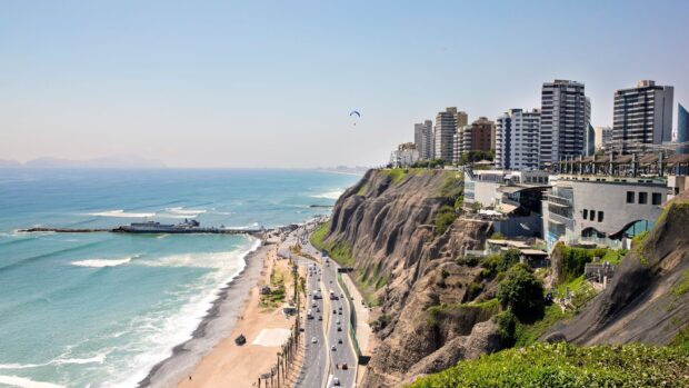 A scenic view of Lima Peru featuring coastal cliffs and buildings by the ocean, HD Desktop Wallpaper