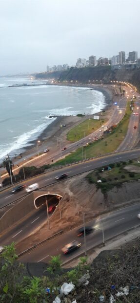 The Lima Peru cityscape shows coastal cliffs and roads near the ocean at dusk, 2K Mobile Wallpaper