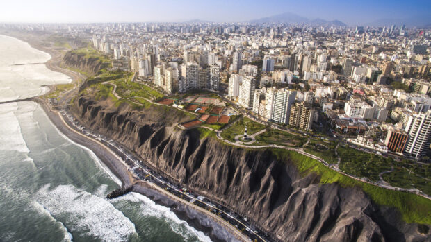 The Lima Peru coastline cityscape shows cliffs, buildings, and sea under clear skies, HD Desktop Wallpaper