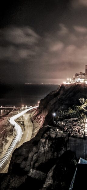 The Lima Peru city lights illuminate the coastline and cliffs at night, HD Mobile Wallpaper