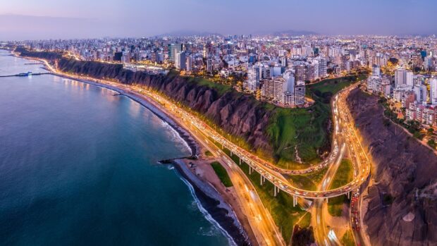 The Lima Peru cityscape shows coastal cliffs and urban lights, HD Desktop Wallpaper