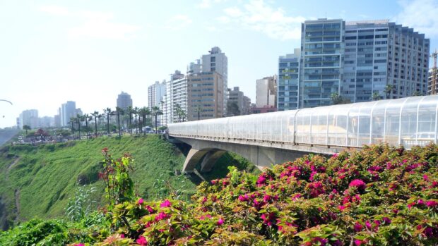 The Lima Peru cityscape shows modern buildings and coastal greenery under a clear sky, HD Desktop Wallpaper