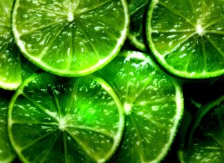 Close up of fresh lime slices showing juicy texture and green citrus segments
