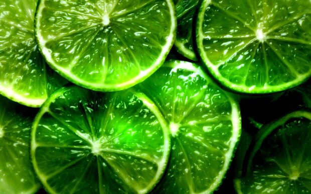 Close up of fresh lime slices showing juicy texture and green citrus segments