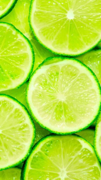 Fresh lime slices with vibrant green color and juicy texture close up