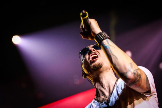 Linkin Park vocalist performing with intense emotion on stage