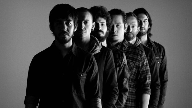 Linkin Park band members standing in a black and white portrait with serious expressions